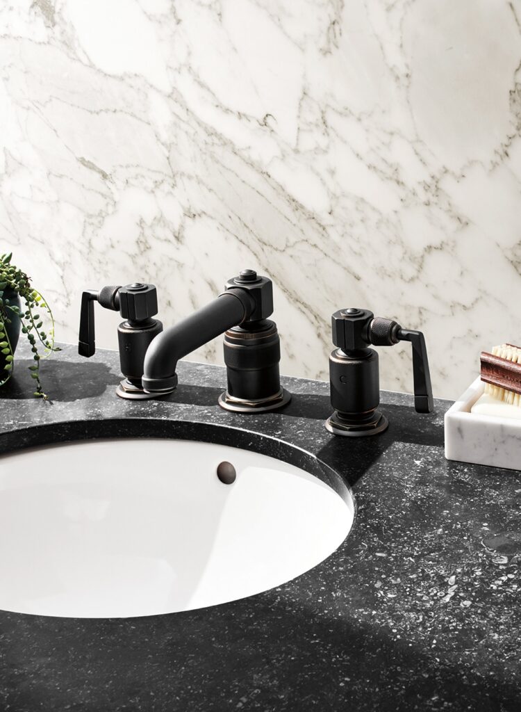 Waterworks R.W. Atlas low-profile bathroom fittings featuring industrial handles and unlacquered finish.