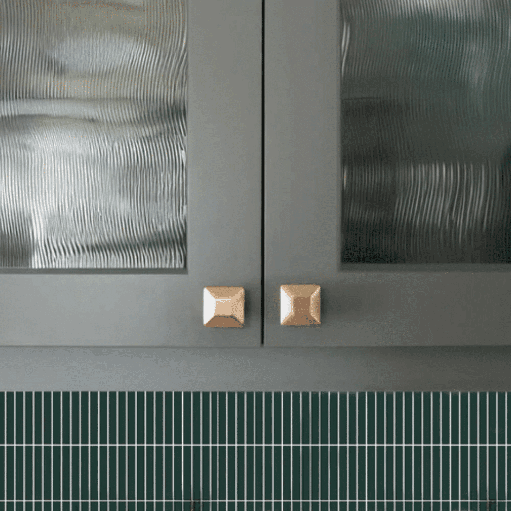 A cabinet with gold, square-shaped luxury kitchen cabinet hardware from Hapny Hardware.