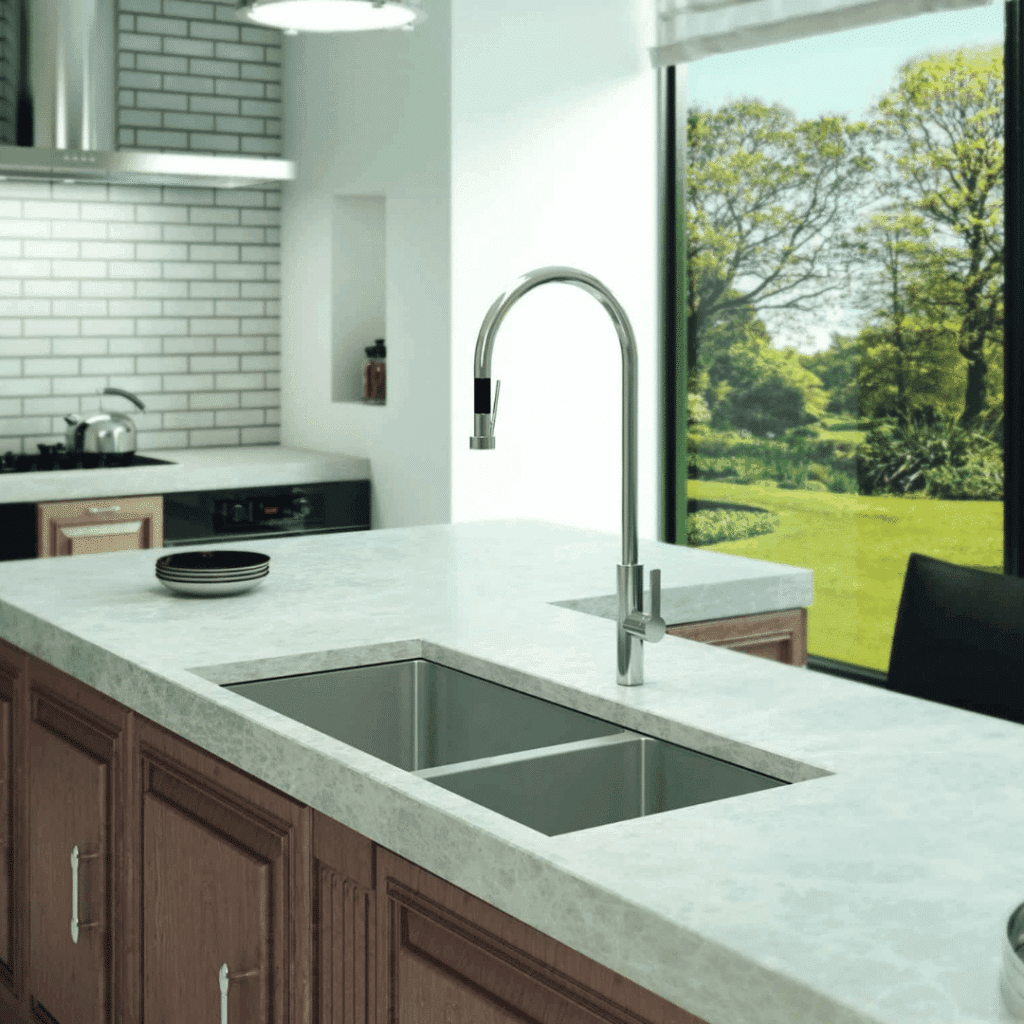A modern kitchen design with a stainless steel kitchen faucet from Franz Viegener and an undermount kitchen sink installed in a white quartz countertop.